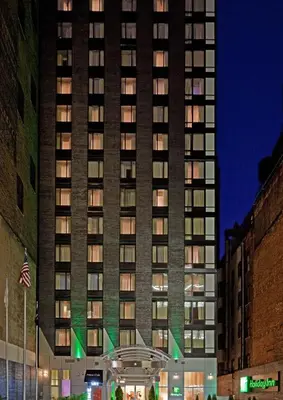 a tall building with lights on in front of it at Holiday Inn Manhattan 6th Ave - Chelsea by IHG in New York