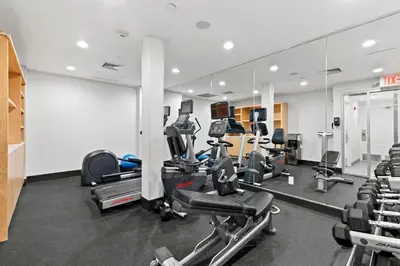 a gym with several treadmills and machines in it at Holiday Inn Manhattan 6th Ave - Chelsea by IHG in New York