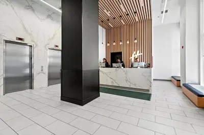 a lobby with two people sitting at a counter at Holiday Inn Manhattan 6th Ave - Chelsea by IHG in New York