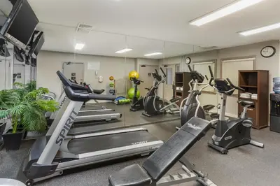 a gym with several treadmills and exercise bikes at Best Western Fort Lee in Fort Lee
