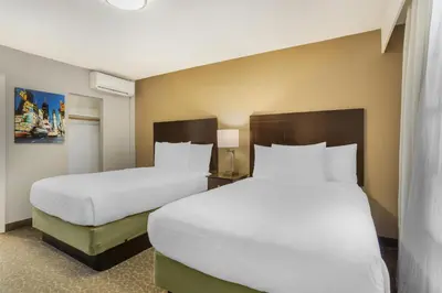 two beds in a hotel room with white pillows at Best Western Fort Lee in Fort Lee