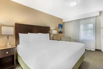 a large white bed in a hotel room at Best Western Fort Lee in Fort Lee