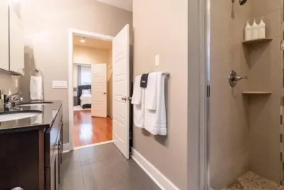 a bathroom with a walk in shower and a sink at Beautiful Lux 4 Bedroom*Near PENN/CHOP*Roof Deck in Philadelphia
