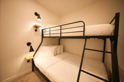 a bunk bed room with two bunk beds and lights at Doxie Hotel in New York