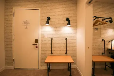 a room with two tables against a brick wall at Doxie Hotel in New York