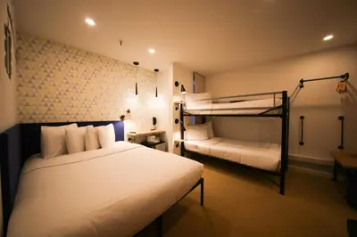 a bedroom with two beds and a bunk bed at Doxie Hotel in New York