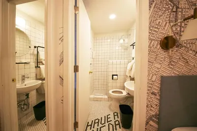 a bathroom with a toilet and a sink at Doxie Hotel in New York