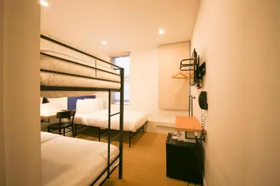 a bedroom with two bunk beds and a desk at Doxie Hotel in New York