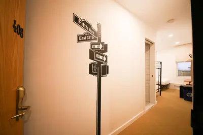 a street sign with many signs in a hallway at Doxie Hotel in New York