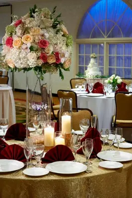 a table with a large arrangement of roses and candles at Clinton Inn Hotel Tenafly in Tenafly
