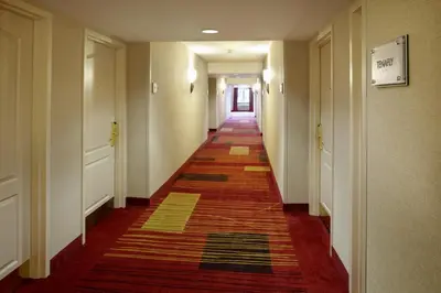 a long hallway with a rug on the floor at Clinton Inn Hotel Tenafly in Tenafly