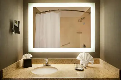 a bathroom with a sink with a mirror and a shower at Sheraton Bucks County Langhorne in Langhorne