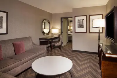 a living room with a couch and a table at Sheraton Bucks County Langhorne in Langhorne