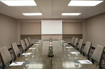 a conference room with a long table and chairs at Sheraton Bucks County Langhorne in Langhorne