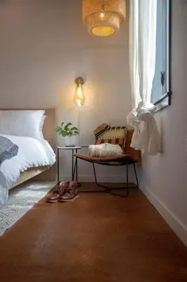 a bedroom with a bed and a chair next to a window at Billy Penn Studio at Kestrel Hotel in Philadelphia