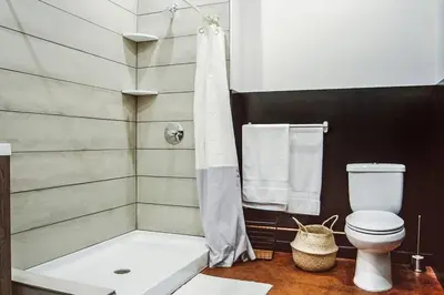 a bathroom with a shower and a toilet at Billy Penn Studio at Kestrel Hotel in Philadelphia