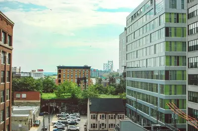 a city with cars parked in a parking lot at Billy Penn Studio at Kestrel Hotel in Philadelphia