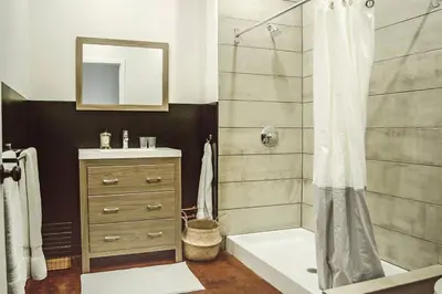a bathroom with a shower and a sink at Poor Richard Studio at Kestrel Hotel in Philadelphia