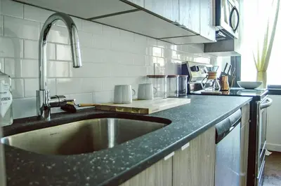 a kitchen with a sink and a counter top at Poor Richard Studio at Kestrel Hotel in Philadelphia