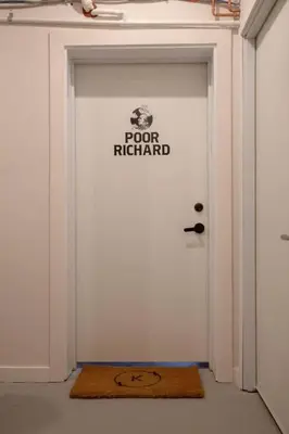 a white door with a rug in front of it at Poor Richard Studio at Kestrel Hotel in Philadelphia