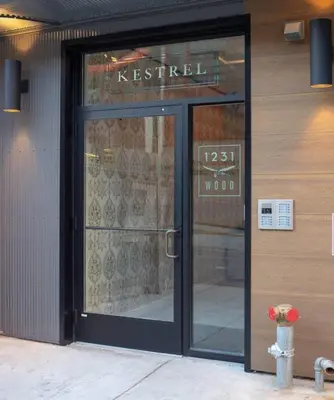 a store front with a glass door with a fire hydrant in front at Rail Park Studio at Kestrel Hotel in Philadelphia
