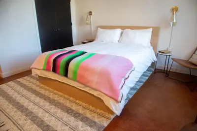 a bedroom with a bed with a colorful blanket on it at Inquirer Studio at Kestrel Hotel in Philadelphia