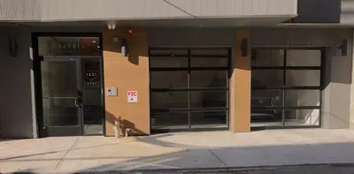 a building with three windows and a fire hydrant in front at Inquirer Studio at Kestrel Hotel in Philadelphia