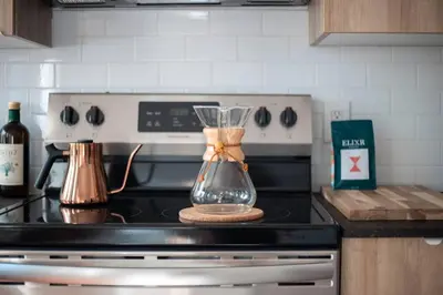 a kitchen with a blender sitting on top of a stove at Inquirer Studio at Kestrel Hotel in Philadelphia