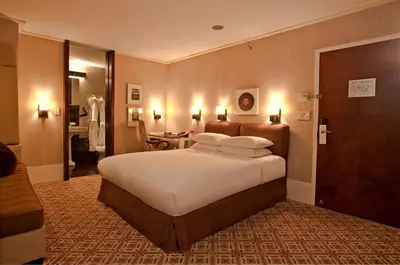 a bedroom with a large white bed in a room at City Club Hotel in New York