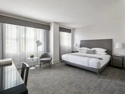 a hotel room with a bed and a chair at AKA Rittenhouse Square in Philadelphia