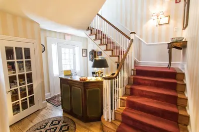 a staircase in a home with a red carpet at La Reserve Bed and Breakfast in Philadelphia