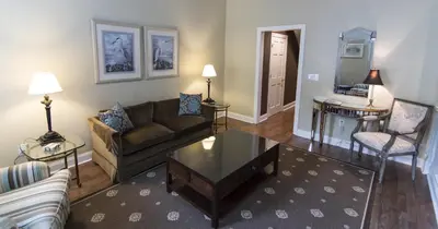 a living room with a couch and a table at La Reserve Bed and Breakfast in Philadelphia