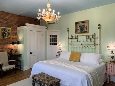 a bedroom with a bed and a chandelier at The Philadelphia Hotel Bella Vista in Philadelphia