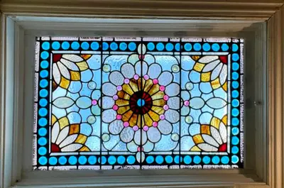 a stained glass window with a flower and butterflies at The Philadelphia Hotel Bella Vista in Philadelphia