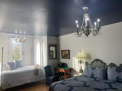 a bedroom with a bed and a chandelier at The Philadelphia Hotel Bella Vista in Philadelphia