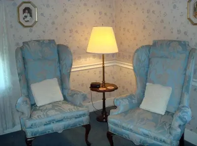 two blue chairs and a lamp in a room at Bird-in-Hand Village Inn & Suites in Bird in Hand