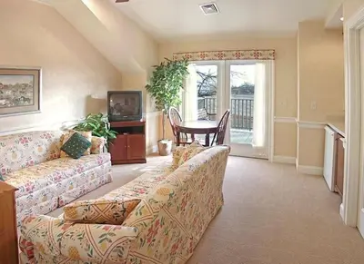 a living room with a couch and a table at Bird-in-Hand Village Inn & Suites in Bird in Hand