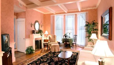 a living room with a fireplace and a tv at Bird-in-Hand Village Inn & Suites in Bird in Hand