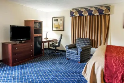 a hotel room with a bed and a tv and a chair at Comfort Inn Feasterville - Trevose in Trevose