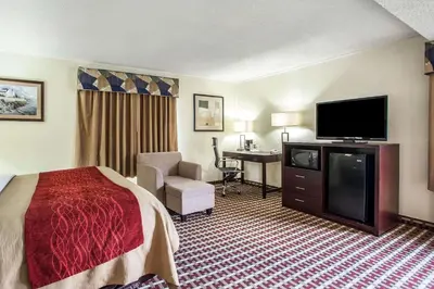 a hotel room with a bed and a flat screen tv at Comfort Inn Feasterville - Trevose in Trevose