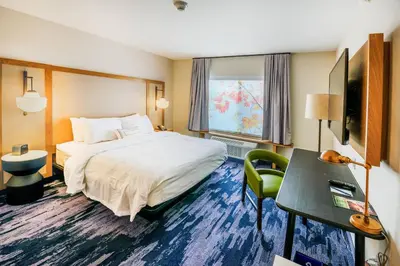 a hotel room with a bed and a desk and a television at Fairfield Inn & Suites Scranton Montage Mountain in Moosic