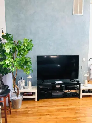 a living room with a flat screen tv on a table at UPDATED Amazing Bi -Level Condo minutes from water views of New York City in North Bergen