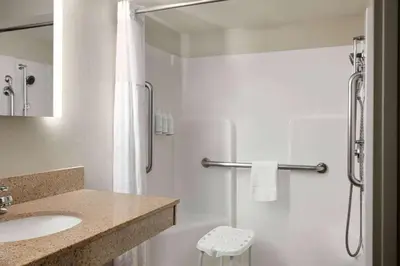 a white bathroom with a sink and a shower at Days Inn by Wyndham Hershey in Hershey
