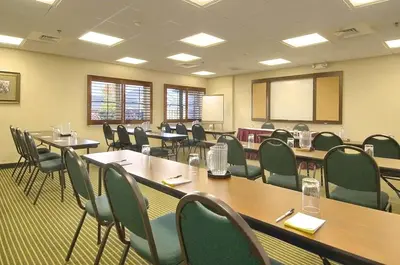 a conference room with tables and chairs and a whiteboard at Days Inn by Wyndham Hershey in Hershey