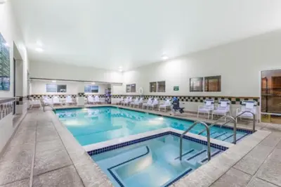 a swimming pool with chairs in a hotel at Days Inn by Wyndham Hershey in Hershey