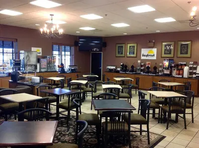 a dining room with tables and chairs in a restaurant at Days Inn by Wyndham Hershey in Hershey