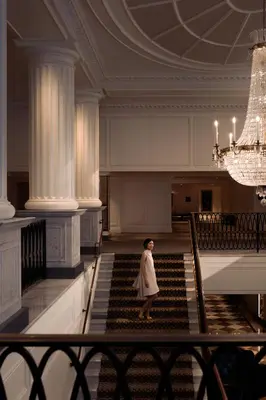 a woman walking down a staircase in a building at InterContinental New York Barclay Hotel by IHG in New York