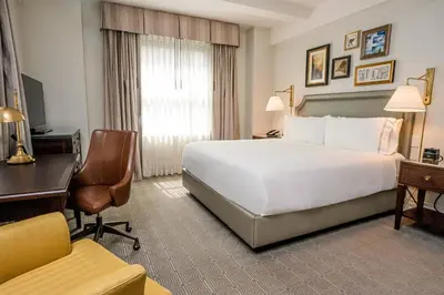 a hotel room with a large white bed and a desk at InterContinental New York Barclay Hotel by IHG in New York
