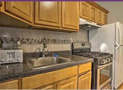 a kitchen with a sink and a stove and a refrigerator at Cozy apt in WEST NY, NEW JERSEY, at 2 bloks from bus stop-15 minutes 2NY 7MINUTES VIA NYWATERWAY FERRY-BETTER CAN'T BE!! in West New York