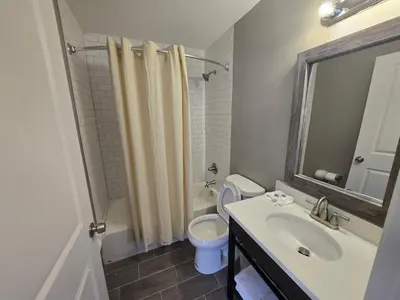 a bathroom with a sink and a toilet and a mirror at Motel 6 East Windsor, NJ Hightstown in East Windsor